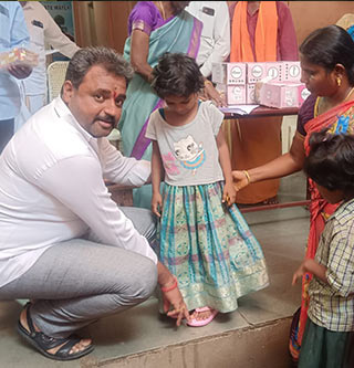 Providing footwear to all the girl children at Annai Sathiya District Govt Home